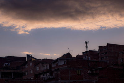 Low angle view of buildings against sky at sunset