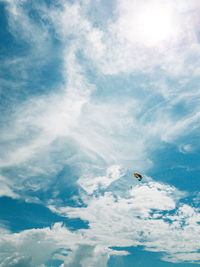 Low angle view of parachute flying in sky