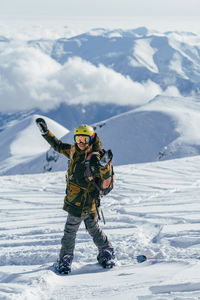 Person with umbrella on snowcapped mountain