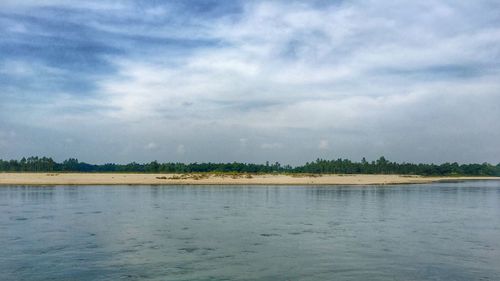 Scenic view of lake against cloudy sky