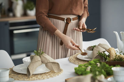 Midsection of man preparing food