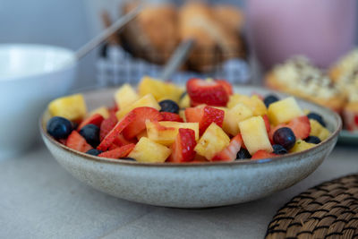 Close-up of chopped fruits in bowl on table