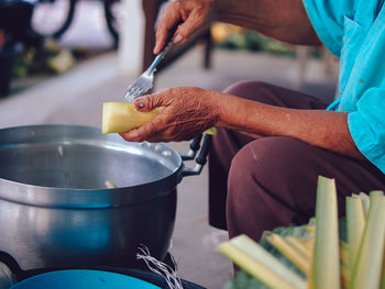 Midsection of man preparing food