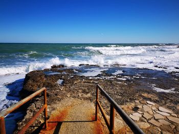 Scenic view of sea against clear blue sky