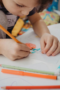 The boy draws with felt-tip pens. high quality photo