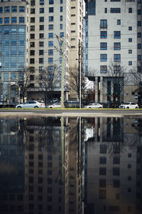 Reflection of buildings on street in city