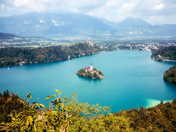 High angle view of bay and city against sky and alps