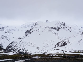 Scenic view of snow covered mountains against sky