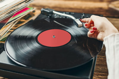 Woman playing music from vinyl record. analog record. retro and vintage style. analog sound. music