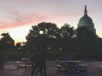 Rear view of people at temple during sunset