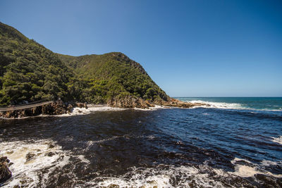 Scenic view of sea against clear blue sky