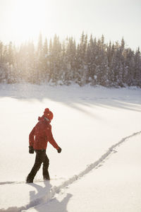 Woman walking through snow