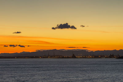 Scenic view of sea against orange sky