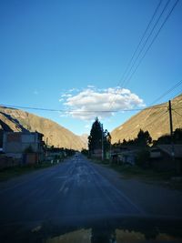 Road against clear blue sky