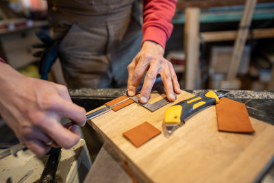 Midsection of man working on table