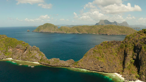 Seascape with tropical rocky islands, ocean blue water, aerial view .