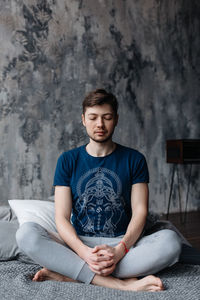 A man engaged in yoga and meditation, performing asanas