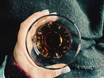 High angle view of hand holding drink