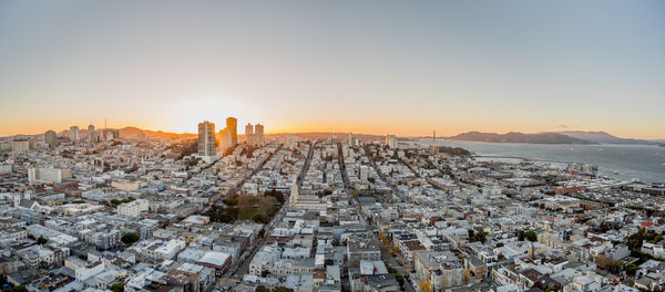 Panoramic view of sea and cityscape against sky