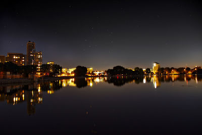 Reflection of illuminated buildings in water at night