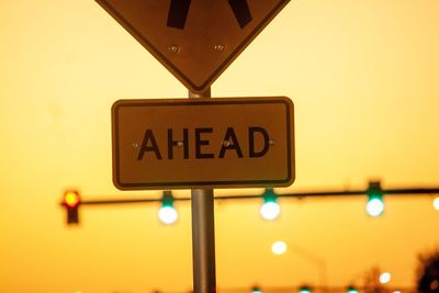 Low angle view of information sign against clear sky