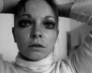 Close-up portrait of young woman at home