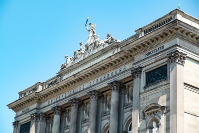 Low angle view of historical building against blue sky