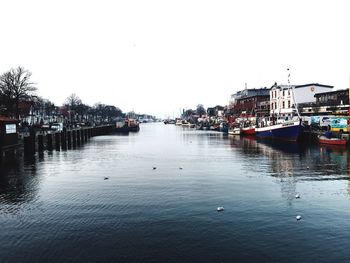 Boats in canal along buildings