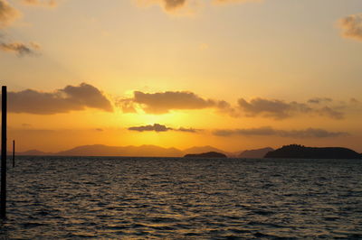 Scenic view of sea against romantic sky at sunset