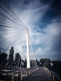 View of suspension bridge against cloudy sky