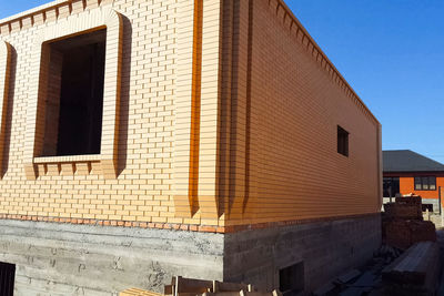 Low angle view of building against clear blue sky