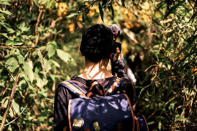 Rear view of woman standing on field