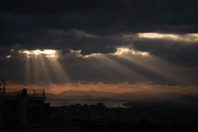 Silhouette buildings against sky during sunset