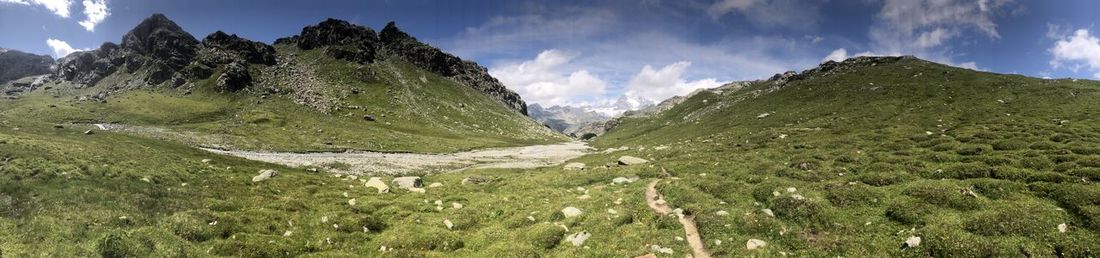 Panoramic view of land and mountains against sky