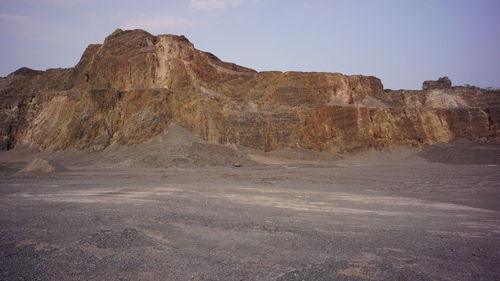 Rock formations on landscape against sky