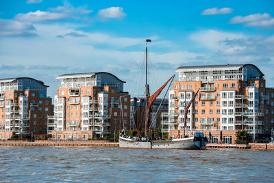 Boats and small ships docked on a river thames in london, uk.