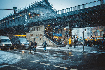 People on road in winter at night