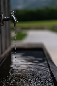 Close-up of water falling from faucet