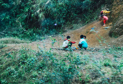 People sitting on land in forest