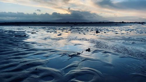 Scenic view of frozen sea against sky during sunset