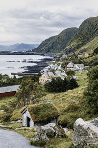 Scenic view of buildings and mountains against sky