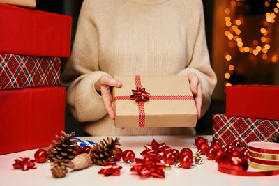 Woman holding gift box in hands. surprise for winter holidays