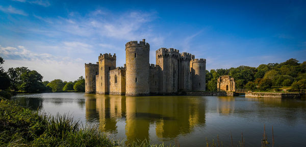 Medieval castle reflecting in the moat on a sunny day 