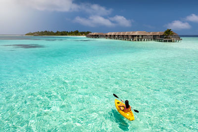 High angle view of woman kayaking in turquoise sea