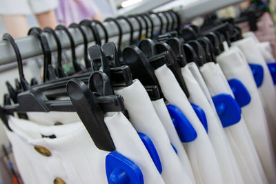 Close-up of skirts hanging on rack in store