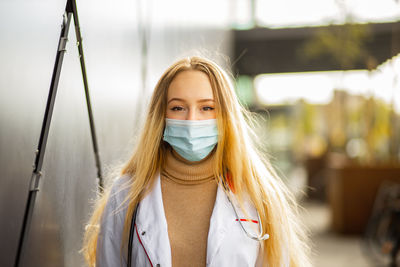 Portrait of young woman wearing mask