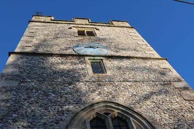 Low angle view of building against clear blue sky