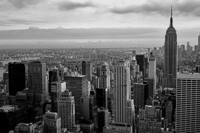 Skyscrapers against cloudy sky