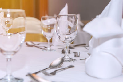 Close-up of wine glasses on table