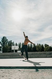Full length of man standing on field against sky